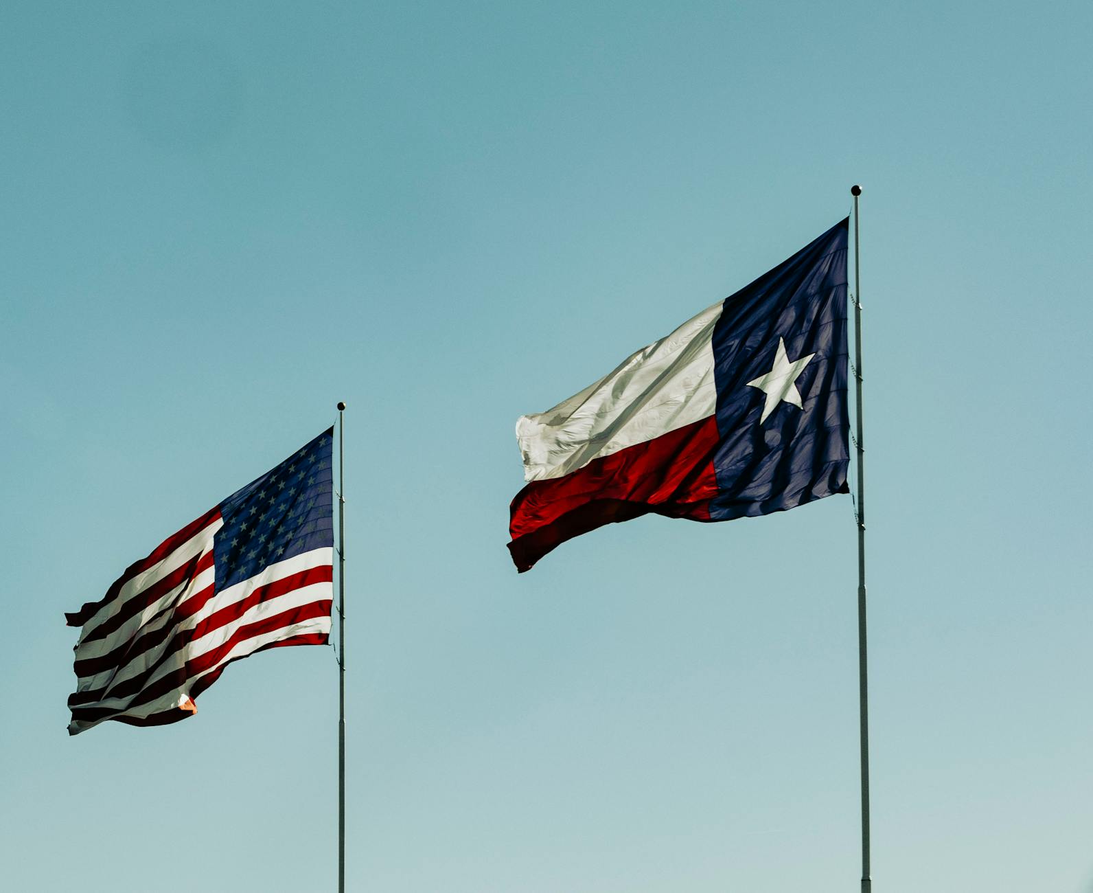 american flag and flag of texas under blue sky This $16.99 Million Home in Fort Worth Could Break Records—Here’s Why