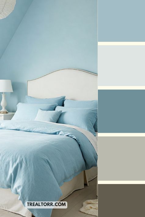 A bedroom with baby blue walls, powder blue bedding, and soft white furniture, creating a light and peaceful atmosphere