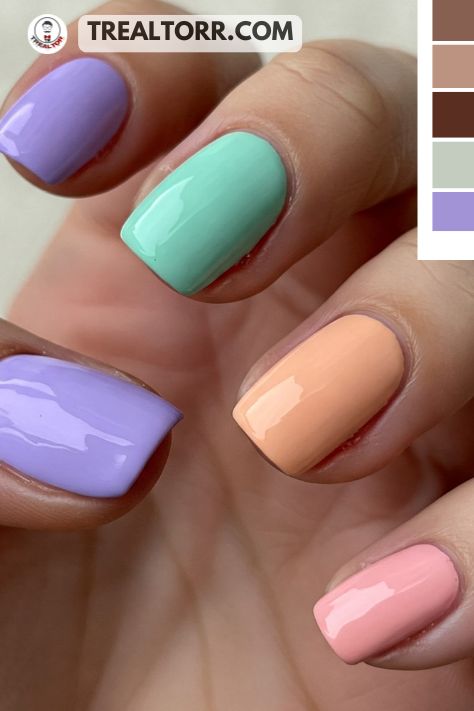 A set of nails with each finger painted in a different pastel color like lavender, mint, peach, and light pink, giving a bright, playful look.