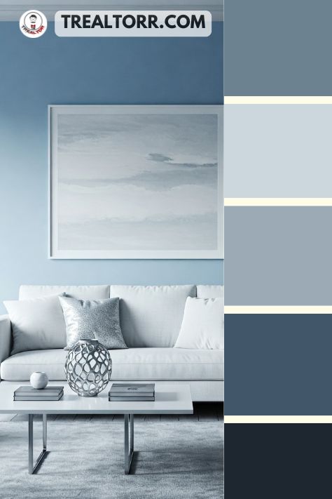 A minimalist living room with arctic blue walls, silver decor, and white furniture, creating a crisp and modern atmosphere