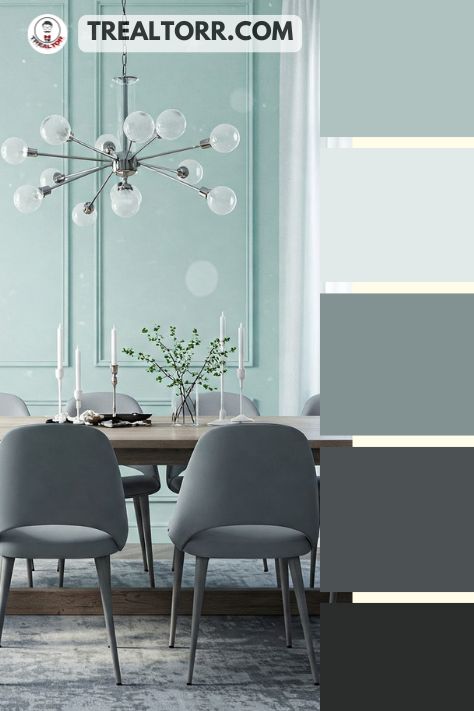 A dining room with icy mint walls, gray chairs, and frosted glass decor, giving off a serene and stylish winter aesthetic.