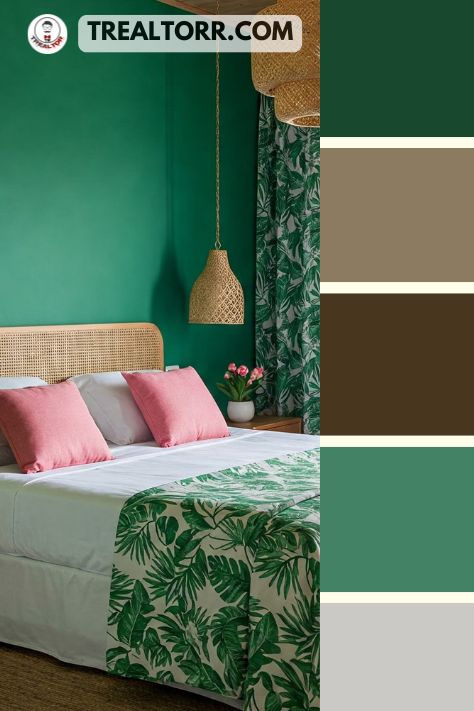 A bedroom with tropical green walls, flamingo pink pillows, and leafy patterns in decor, complemented by wooden furniture for a tropical oasis feel