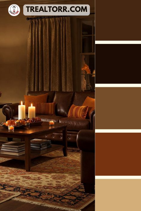 A living room with chocolate brown furniture, pumpkin spice throw pillows, and soft lighting, styled with warm-toned rugs and candles
