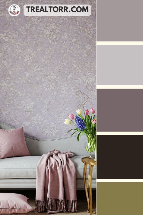 A cozy reading nook with pale lavender walls, dusty rose cushions, and light gray furniture, accented with gold details and springtime florals.