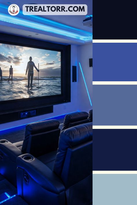 A modern luxury home theater with sleek black recliners, an oversized screen, ambient blue LED lighting, and minimalist decor