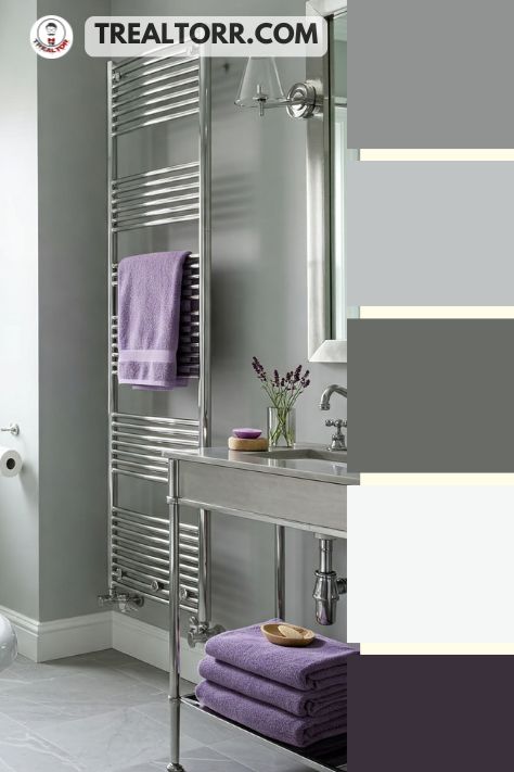 A bathroom with lavender towels, pale gray walls, and silver accents, creating a serene and spa-like atmosphere.